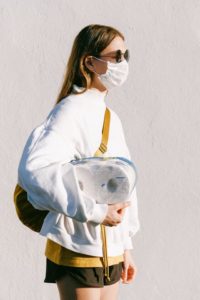 woman in mask holding toilet paper 2019 coronavirus disease myths